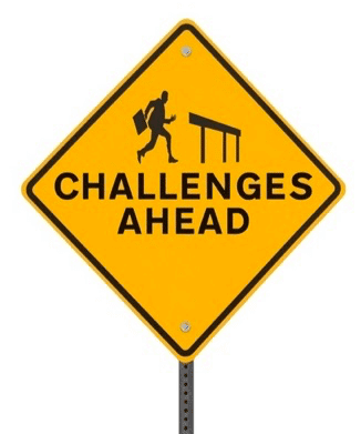 Street sign reading "challenges ahead"